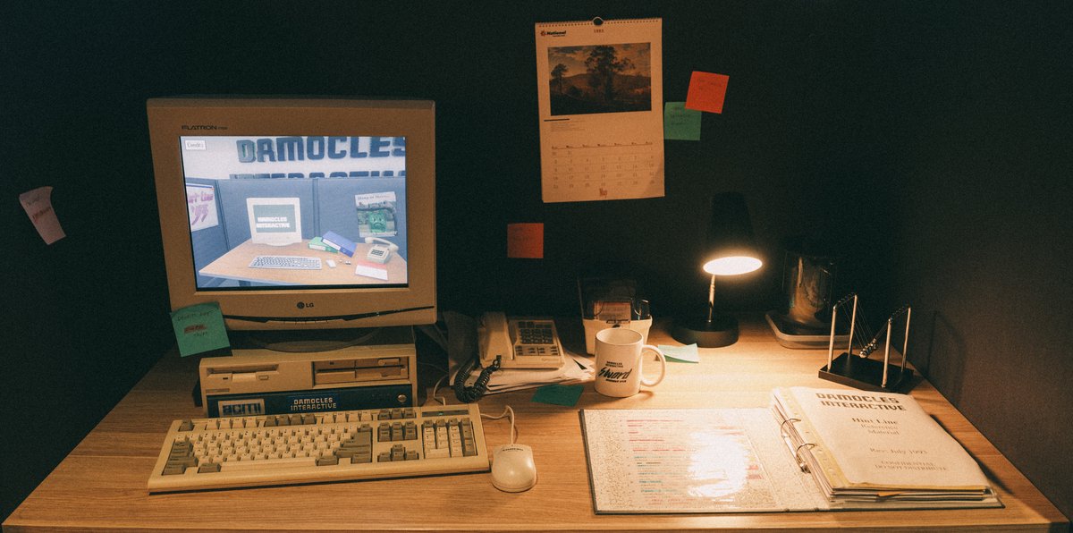 The Hint Line '93 installation at ACMI — a recreated 1990s office desk with CRT monitor, mechanical keyboard, and The Compendium binder